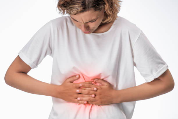 istock Young Woman Suffering From Stomach Pain 2180230198