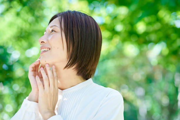 istock A woman checking her skin condition 2180233442