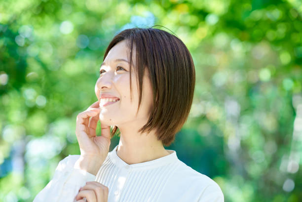istock A woman checking her skin condition 2180233683