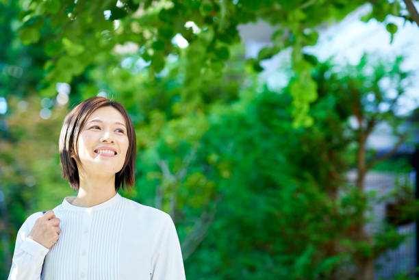 Woman walking in green space on fine day