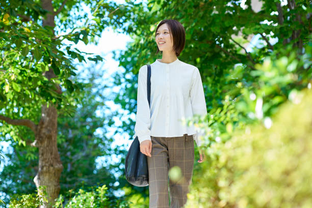 istock Woman walking in green space 2180233914