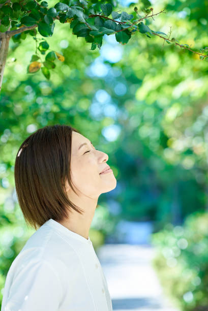 istock Smiling woman in the greenery 2180233980