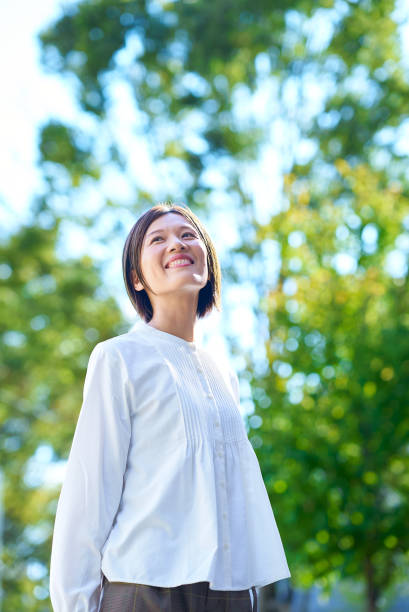 istock Smiling woman in the greenery 2180234021