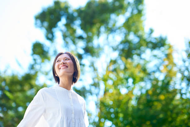 istock Smiling woman in the greenery 2180234069