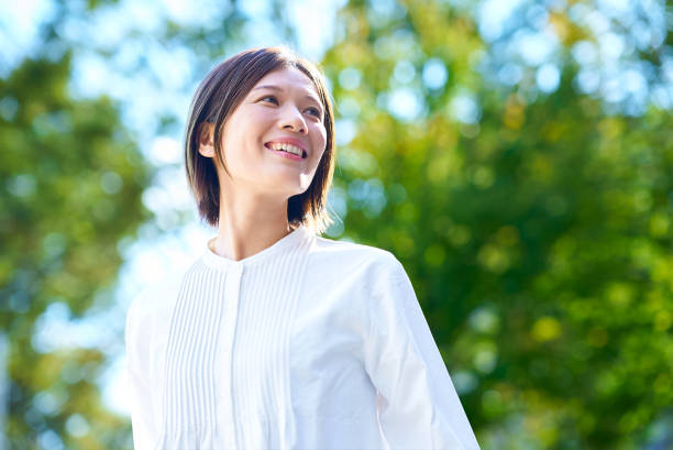 istock Smiling woman in the greenery 2180234112