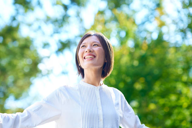 istock Smiling woman in the greenery 2180234156