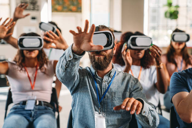 istock People wearing virtual reality VR goggles during a conference 2180235560