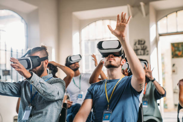 istock People wearing virtual reality VR goggles during a conference 2180235563