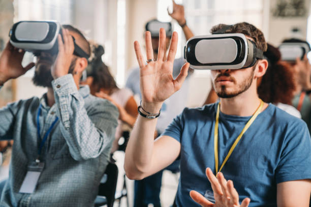 istock People wearing virtual reality VR goggles during a conference 2180235564
