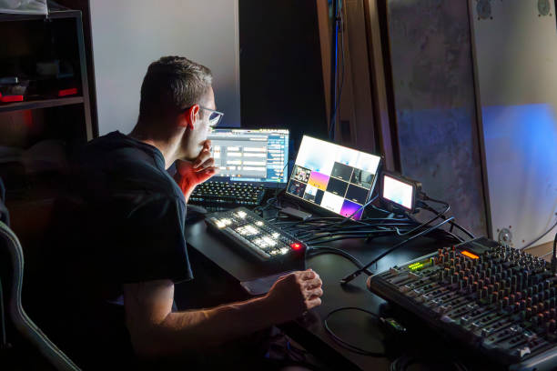 istock Video Director Managing Multiple Screens and Equipment in a Control Room During a Live Broadcast 2180240961