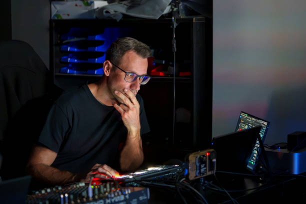 istock Video Director Managing Multiple Screens and Equipment in a Control Room During a Live Broadcast 2180240998