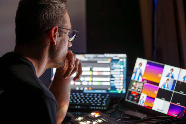 istock Video Director Managing Multiple Screens and Equipment in a Control Room During a Live Broadcast 2180241040