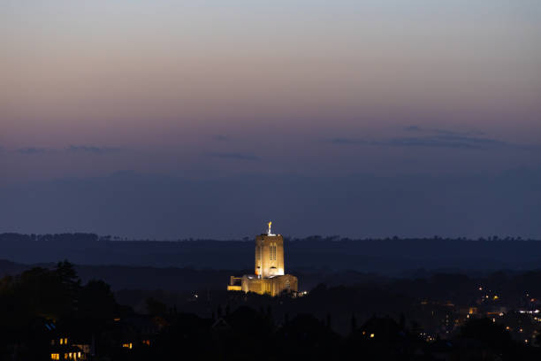 Lucca old skyline at sunset with cathedral bell tower silhouette and golden clouds
