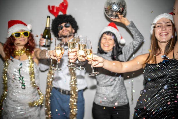 istock Group cheers with champagne under festive confetti shower 2180244974