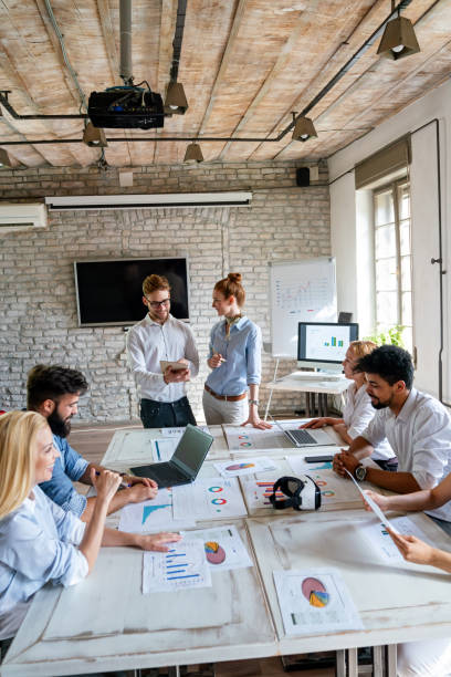 istock Group of young multi-ethnic startup business team collaborating on project in modern office 2180249456