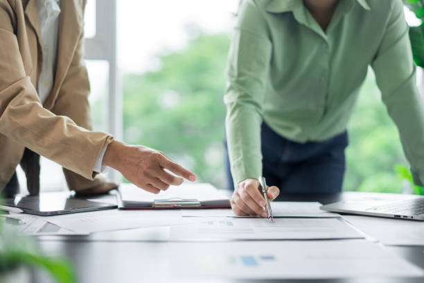 istock Alternative energy environment businesspeople checking document and discuss about renewable energy 2180249565