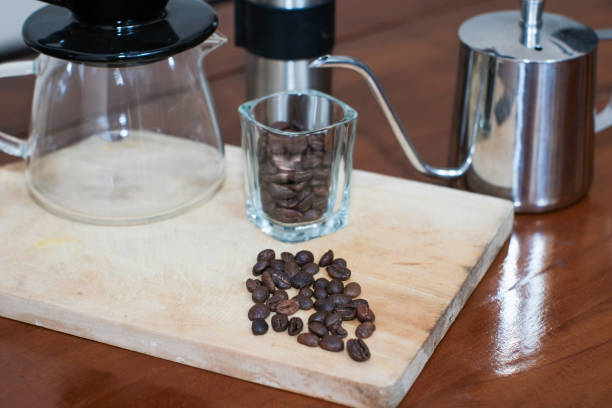 V60 coffee method of making coffee with Complete V60 set tools on the wooden table, making homemade coffee.