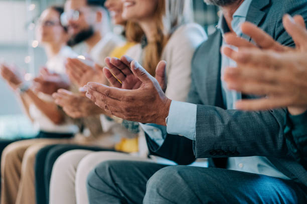 istock Businesspeople applauding during a seminar in conference hall. 2180253830
