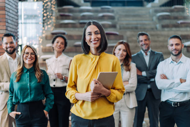 istock Confident businesswoman and her team. 2180253894