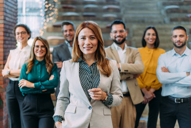 istock Confident businesswoman and her team. 2180253900