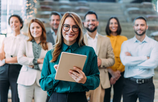 istock Confident businesswoman and her team. 2180253905
