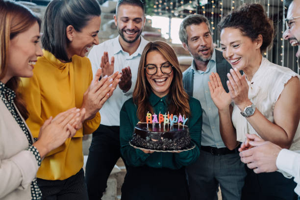 istock Team celebrating a birthday at the office. 2180253923