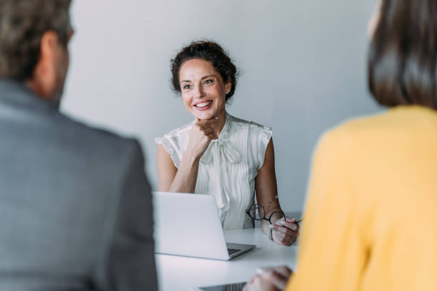 istock Group of business persons talking in the office. 2180253988