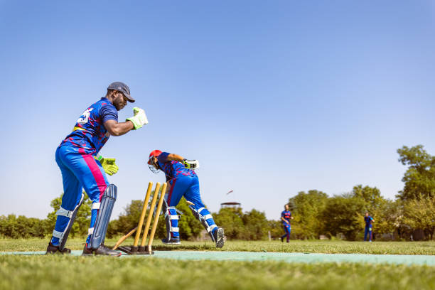 istock Cricket Match in Action with Blue Uniforms 2180256214