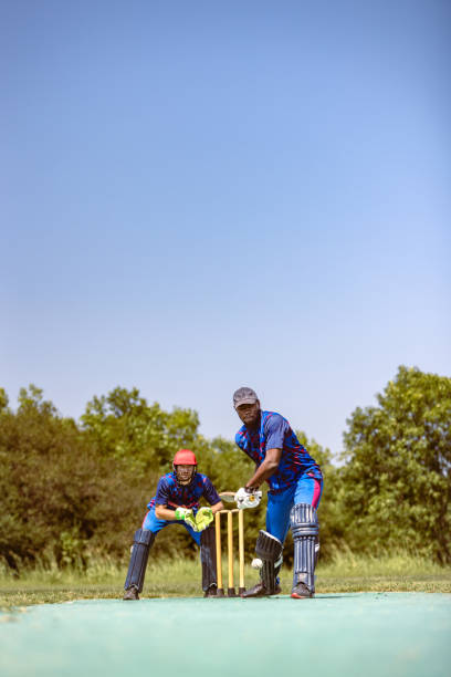 istock Cricketer Batsman Ready to Hit Ball with Wicket Keeper 2180256228