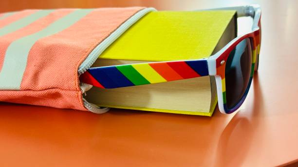 istock Book in a beach bag with rainbow sunglasses 2180257304