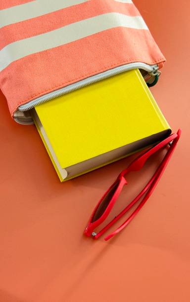 Close-up taken of Digital e-book reader stand with a blank screen on the white background with a glasses,paper books and coffee cup