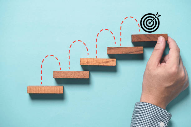 istock Hand putting virtual target board and arrow which print screen on wooden cube. Business achievement goal and objective target concept. 2180257406