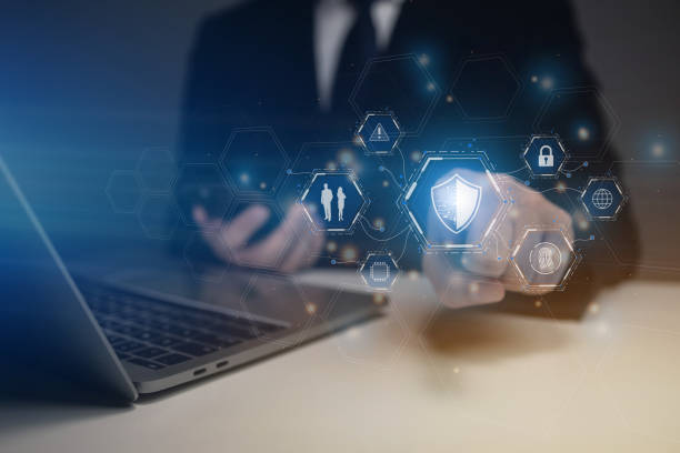istock A man is using a laptop with a blue shield icon on the screen 2180262247