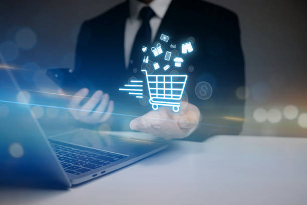istock A man is holding a cell phone and a laptop 2180262249
