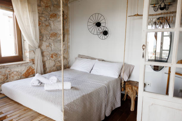 Beautiful bedroom with stone walls and white furniture without people
