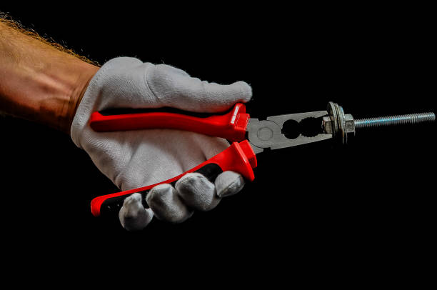 istock A person is holding a pair of pliers with a red handle 2180264376