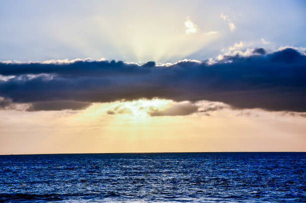 istock The sky is blue and the sun is shining through the clouds 2180264413