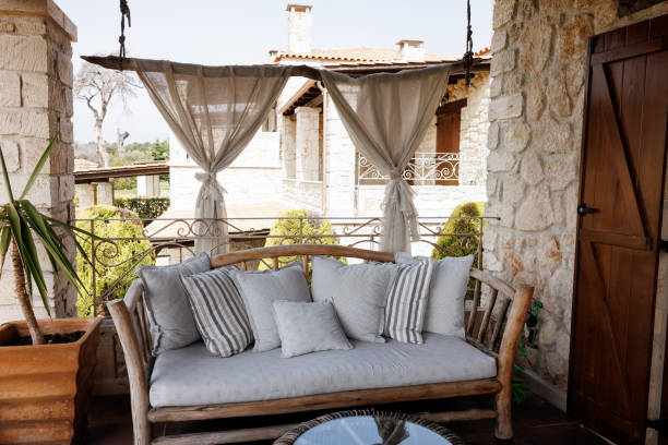 Beautiful sunny patio with sofa and coffee table during the day without people
