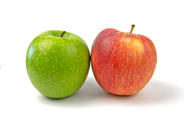 Three red apples and two green ones on a red background