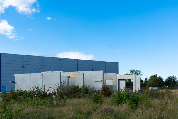 istock Concrete construction panels on a vacant lot in front of a building. 2180266145