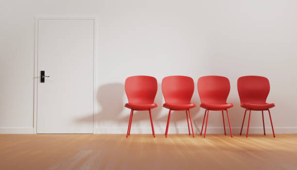 istock Four empty red chairs in front of the interview room 2180268046