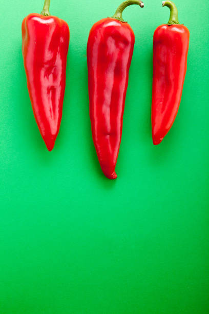 Two red bell pepper quarters on white background