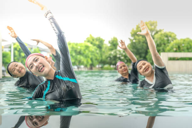 istock An engaging aquatic exercise class for seniors led by an instructor in a pool. The participants use colorful foam noodles, practicing water-based exercises to stay fit, healthy, and active. 2180271834