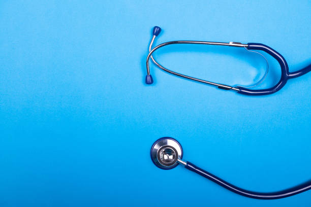 istock Medical stethoscope on background in studio photo. Top view 2180276063