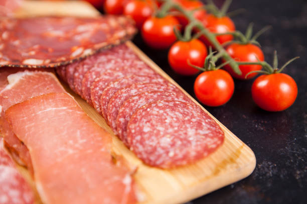 istock Close up of meat appetizers next to cherry tomatoes 2180280457