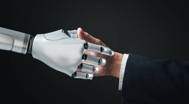 istock A robotic hand and a human hand engage in a handshake, demonstrating partnership. 2180282574