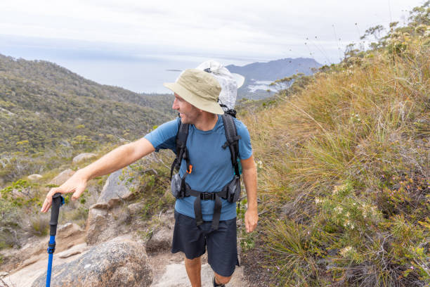 istock Hiker Walking on Mountain Trail with Trekking Pole 2180287189