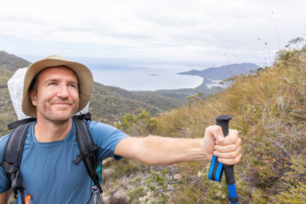 istock Hiker Walking on Mountain Trail with Trekking Pole 2180287247