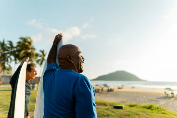 Senior surfer man looking away on the beach