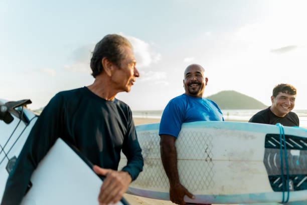 istock Surfer friends talking on the beach 2180287872